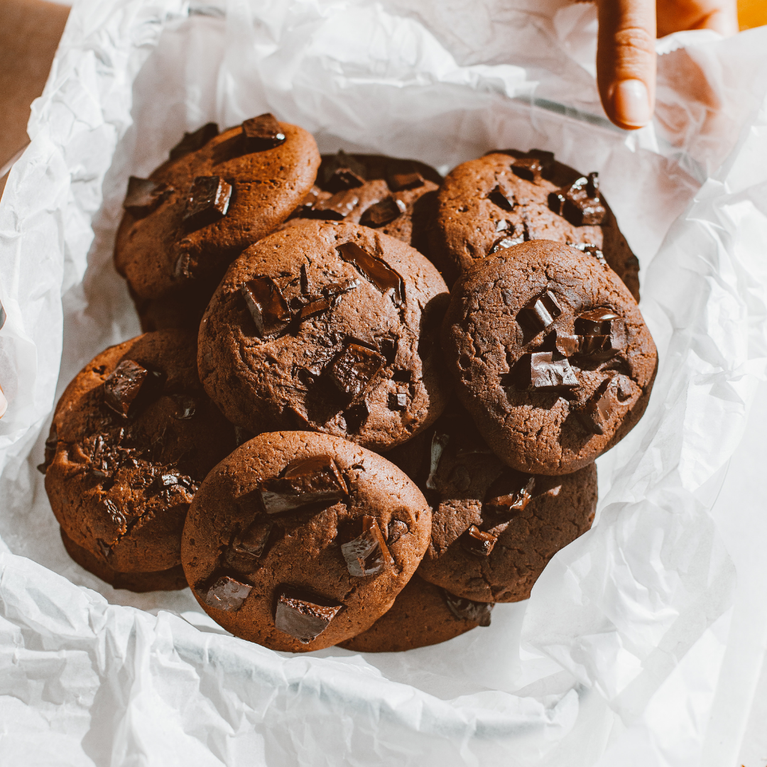 pile of chocolate cookies on sheet of white baking paper